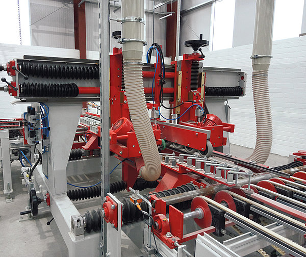 SR SCHINDLER chamfering machine with guides and extraction hoses for edge finishing of concrete products.